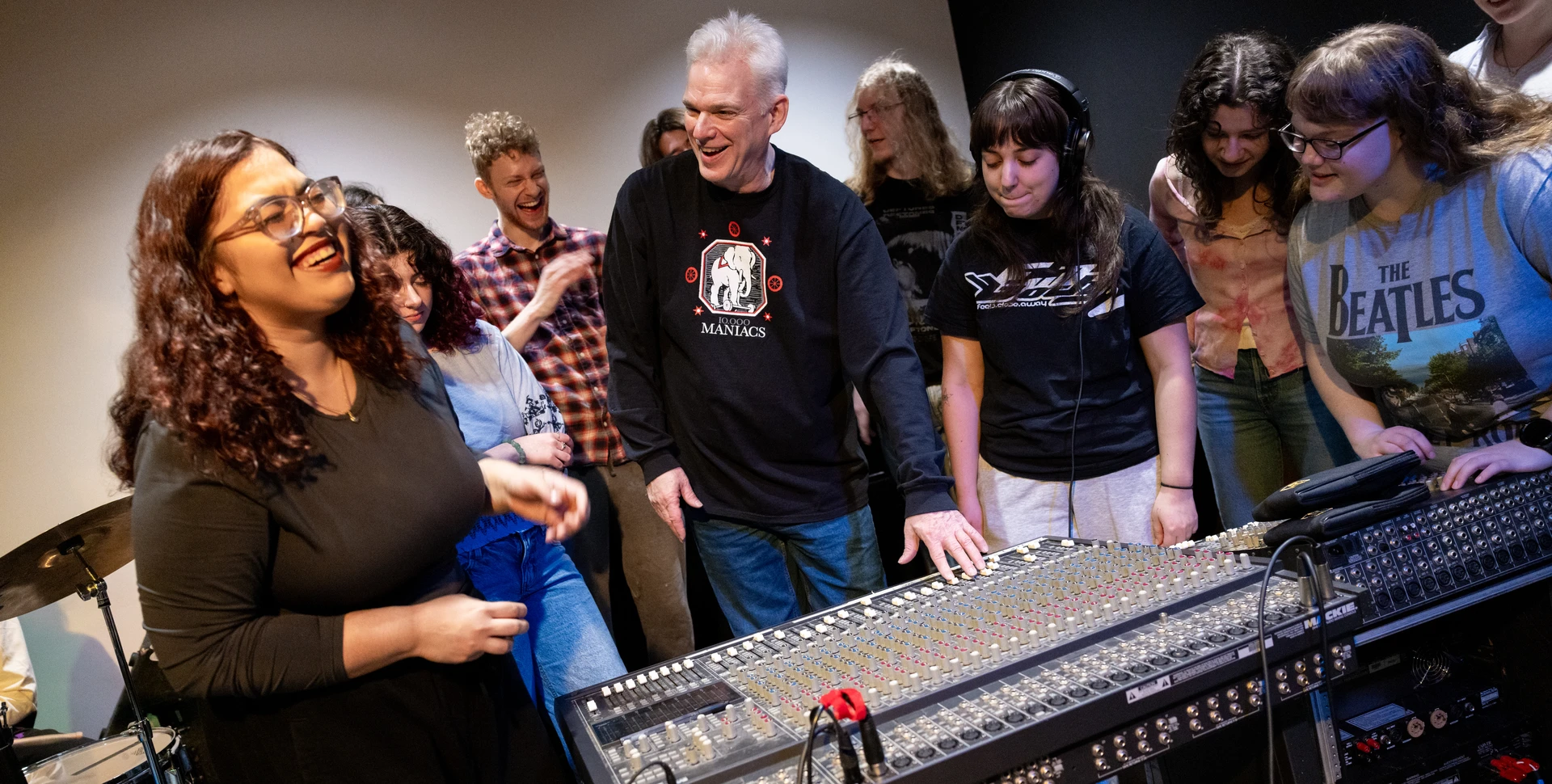 Students in the business of music industry program working in the studio