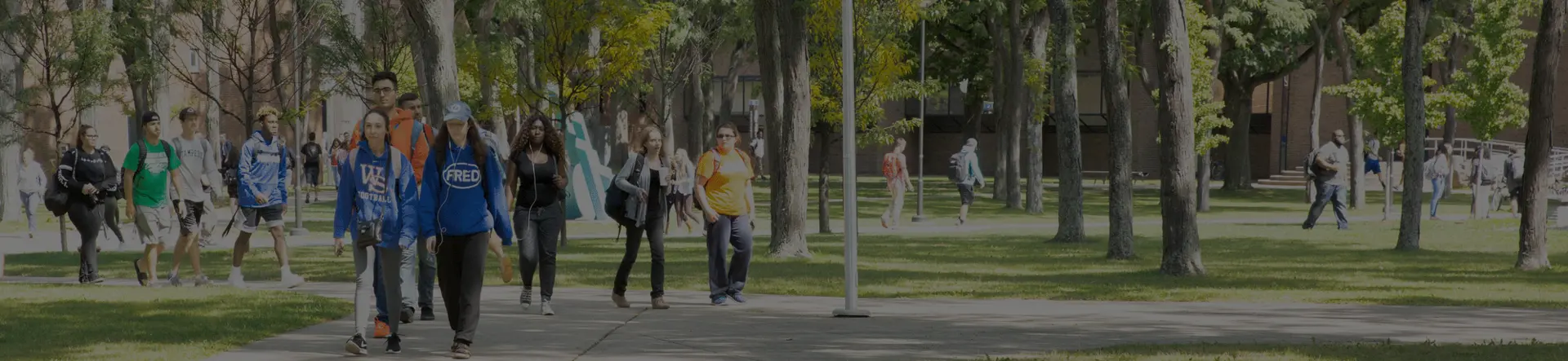 Students walking across campus on a typical summer day. With affordable tuition, 65+ majors and programs, and a supportive campus, transfer students find a welcoming environment.