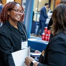 Fredonia student meeting with professionals at a campus event