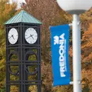 Fredonia clock tower with fall leaves  