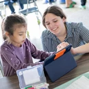 Fredonia student teacher working individually with a student