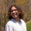 Fredonia student on campus enjoying the sunshine on a spring afternoon