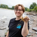 Geology student holding up a small freshwater crab