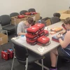 students assembling AED units