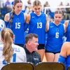 Coach Braun coaching surrounded by team members