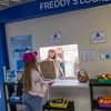 student being given a bag of food at Freddy's Locker