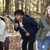 students searching in the woods