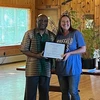 Alicia Klepfer receives her award from President Stephen H. Kolison Jr.