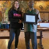 Stephanie Teachman accepts the 2025 Poummit Secretarial Award from President Dr. Stephen H. Kolison Jr. 