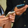 people texting on their phones