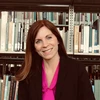Dr. Emily VanDette in front of bookshelves