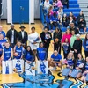 basketball and cheer squad with families in gymnasium