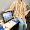 James Gibbons, in a Michael C. Rockefeller Arts Center animation lab, with his a scene from his documentary displayed on a monitor.