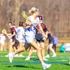 lacrosse players in action on the field