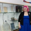 Amanda Shepp, coordinator of Special Collections and Archives in Reed Library, stands in front of the bicentennial exhibit set up in Fenton Hall
