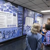 Mural artist Erin Ruffino ('19) talks about the display with members of the audience who attended the ribbon-cutting event on August 6