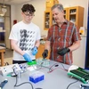 Gradimir Mesarich, a junior Molecular Genetics major, and Associate Professor Scott Ferguson discuss a procedure to determine if a segment of DNA is amplified.