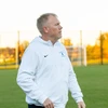 Coach Chris Case walking on the field