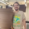 Ethan Brooks in front of ceramic pot in studio