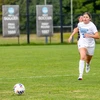 soccer player Annie Gondek running down the field by Travis Bernhard
