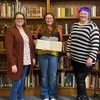 Angelina “Angie” Seamster, displaying a book of sheet music, is joined by Katelynn Telford (left), music and arts librarian, and Amanda “Mandi” Shepp, coordinator of Special Collections & Archives. 
