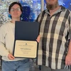 Syd Lamberton accepts the award for Resident Assistant of the Month from Residence Director of University Commons and Gregory Hall Jacob Steinhoff.