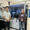 Dr. Wentao Cao and Mia Enders, alongside an XRD (x-ray diffraction) machine at the Pacific Northwest National Lab.