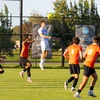 soccer players in action on the field by Travis Bernhard