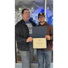 former Student of the Month receiving his certificate