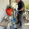 Dr. Ted Lee cleans a water filter during his Fulbright Fellowship in Honduras.