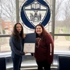 Sydney Hawkins holding certificate and Kasling Hall Director Sabrina Sosa.