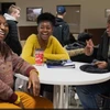 students sitting around a table laughing