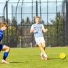 soccer players in action on the field by Travis Bernhard