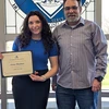 Anna Sheehan holding certificate standing with staff member who nominated her for the award