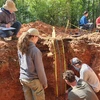 students examining soils in a pit