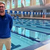 Portrait of Ryan Kreuser, head coach of Fredonia State swimming and diving beside pool