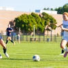 women playing soccer by Travis Bernhard
