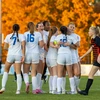 women soccer players celebrating on the field