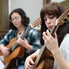 Fredonia students, like the woman playing guitar, can earn a music minor