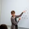 a professor explains a math problem to students. major in mathematics, mathematics major, mathematics degree, degree in mathematics, math degrees.