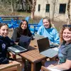 Fredonia students enjoy spring sunshine while studying outside. Consider a major in gender and ethnic studies 