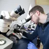 Students Jennifer Able and Jeremy Smith run tests and record data during their spring internships at TimberFish.  master biology.